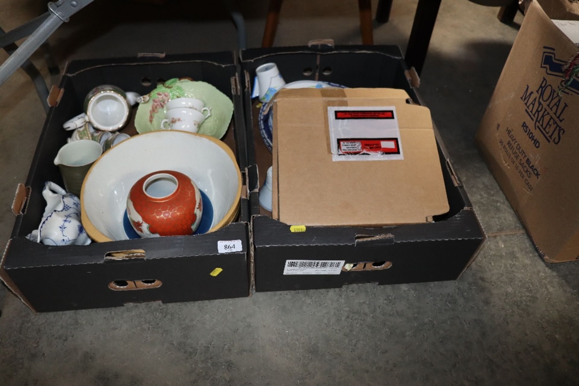 Two boxes containing various patterned tea and di