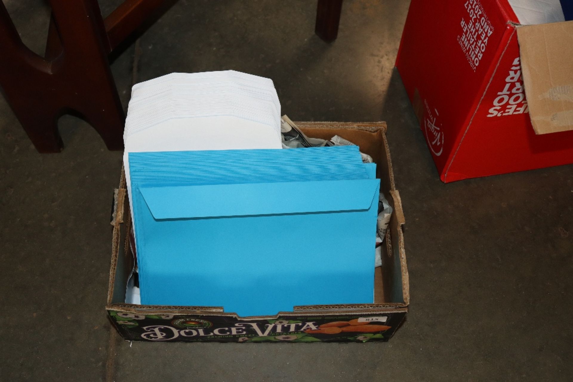 A box containing C4 Caribbean blue envelopes and C