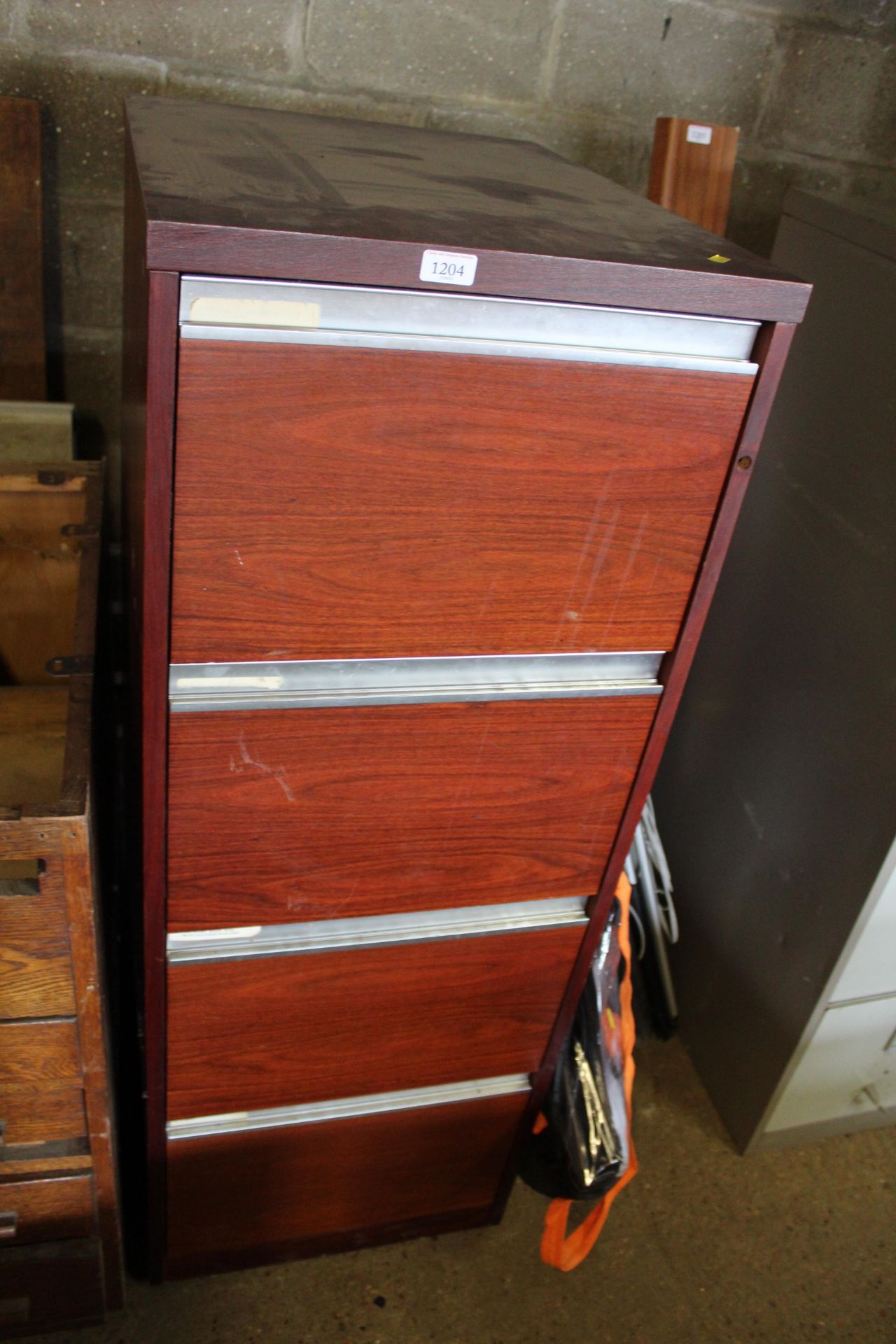 A four drawer filing cabinet (locked, no key)