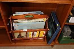 A magazine rack and a quantity of various records