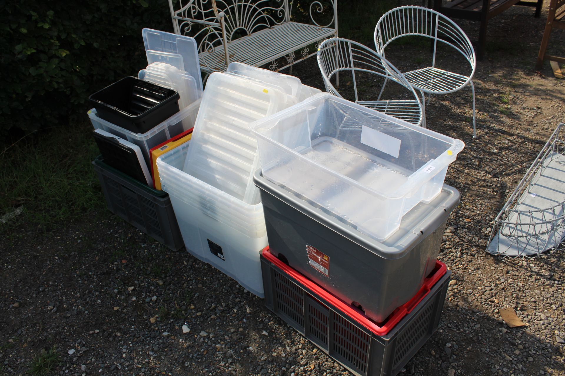 A quantity of plastic storage boxes and lids