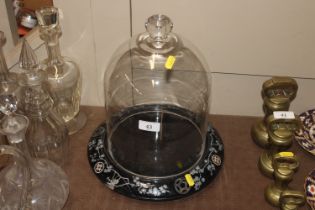 A glass dome on ceramic stand