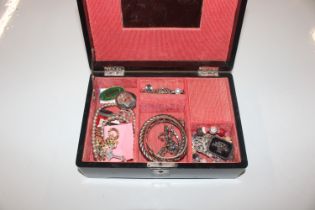 A black lacquered jewellery box and contents to in