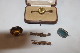 A yellow metal bar brooch set with citrine coloure