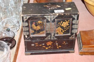 An Oriental lacquered trinket cabinet