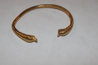 A yellow metal bangle, tested as 24ct gold approx.