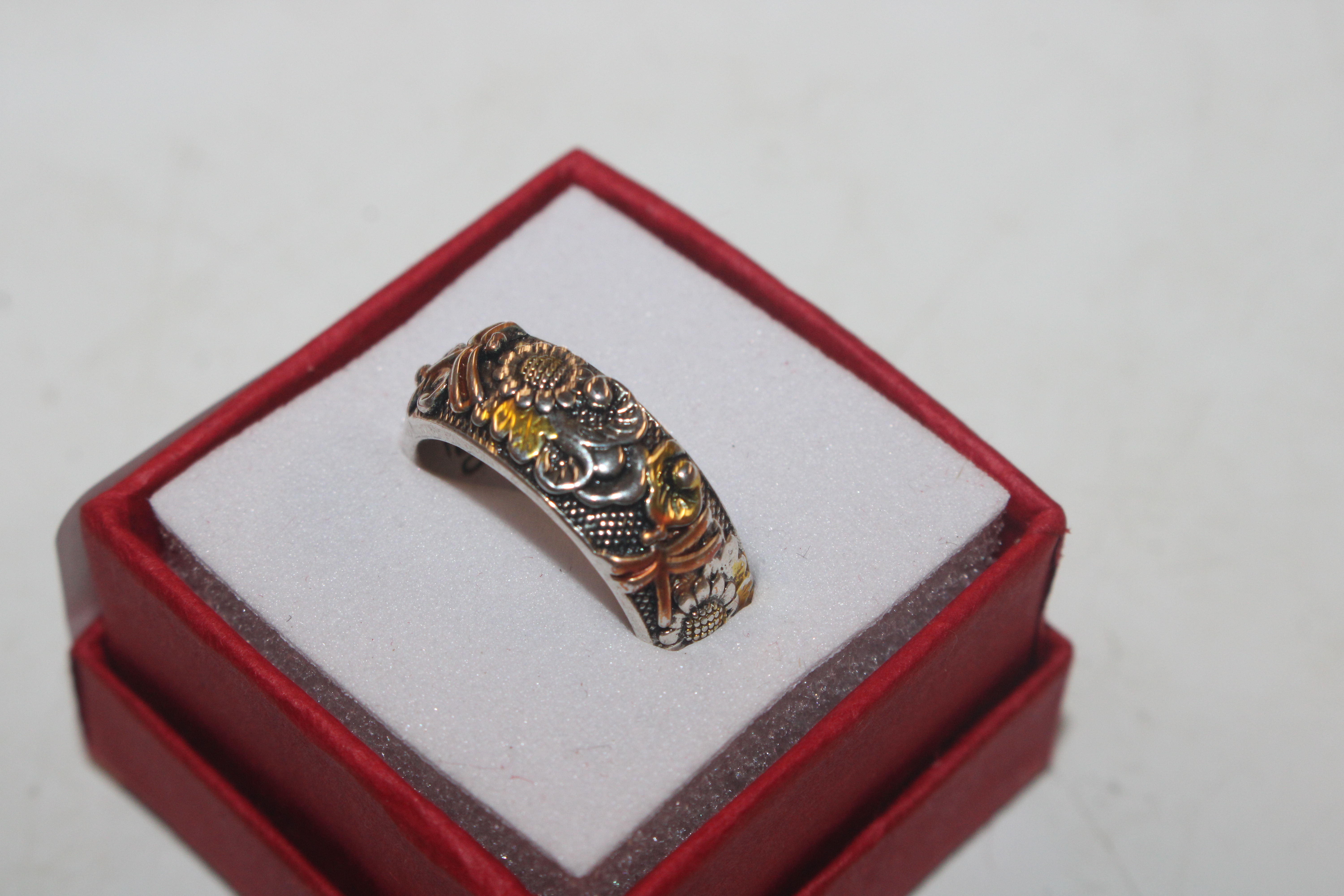 A Sterling silver ring with gold dragonfly detail,