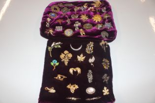 Two cushions of various brooches and costume brooc