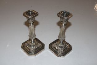 A pair of silver candlesticks with removable drip