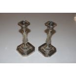 A pair of silver candlesticks with removable drip