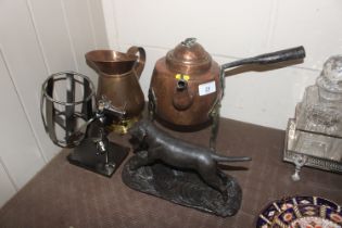 An antique copper side pouring kettle with iron ha