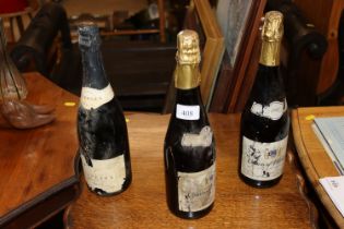 Three old bottles of sparkling wine