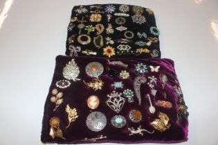 Two cushions of various brooches and costume brooc