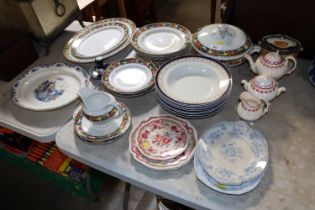 A collection of floral decorated dinnerware and va