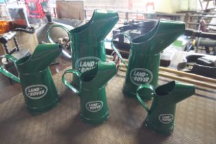 A graduated set of metal Land Rover oil cans (126)