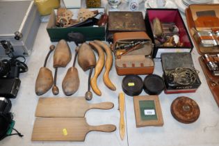 A collection of wooden items including butter pats, leather case tape measures, crumb brushes etc