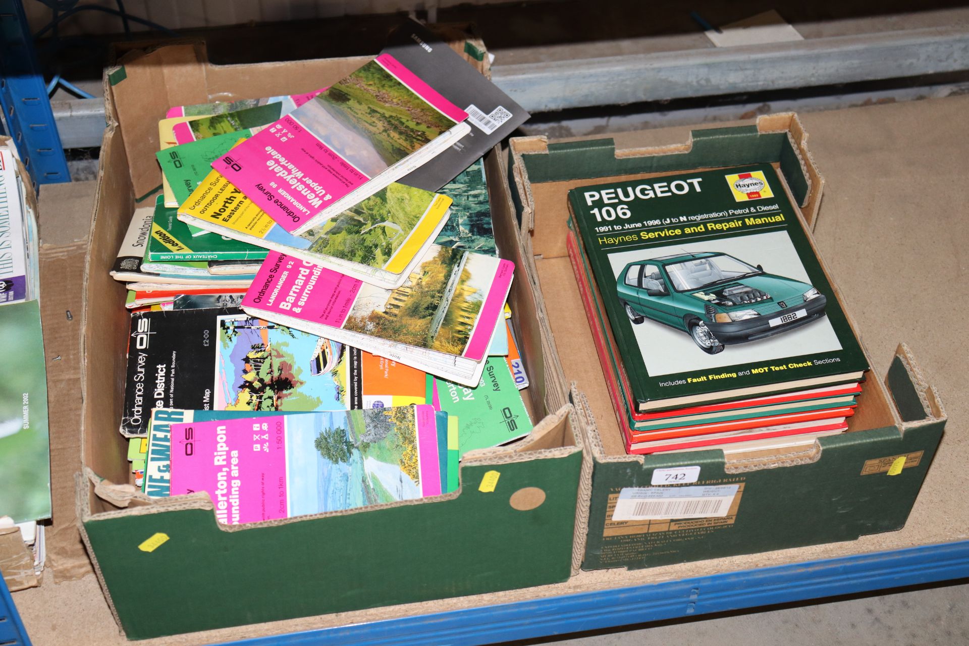 A box of Haynes manuals and a box of Ordnance Surv