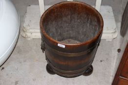 An oak and brass bound coopered log bin