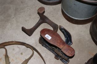 A cast iron adjustable shoe last and another