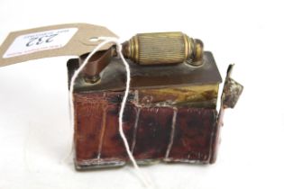 A McMurdo cigarette lighter with leather crocodile