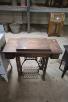 An oak cased treadle sewing machine