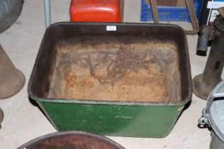 A vintage green painted cast iron quenching trough