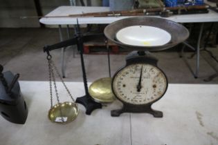 A set of iron and brass balance scales and a house