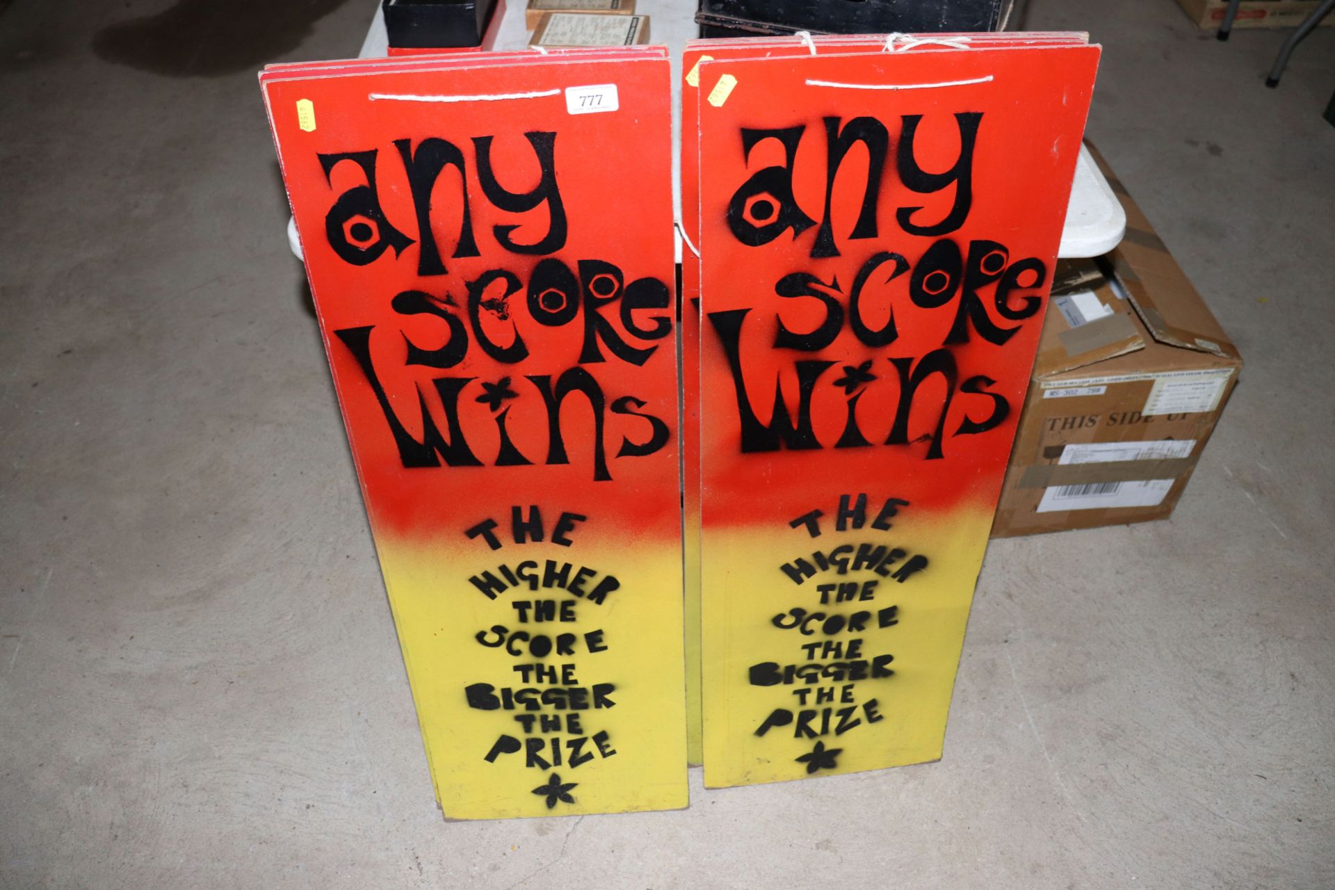 Seven "Any Score Wins" fairground signs