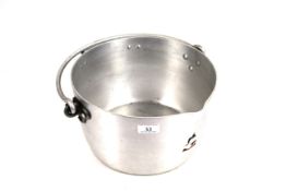 A large aluminium cooking pot with handle