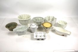 A collection of white glazed china jelly moulds an