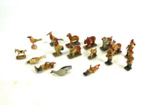 A collection of painted wooden animal and other fi