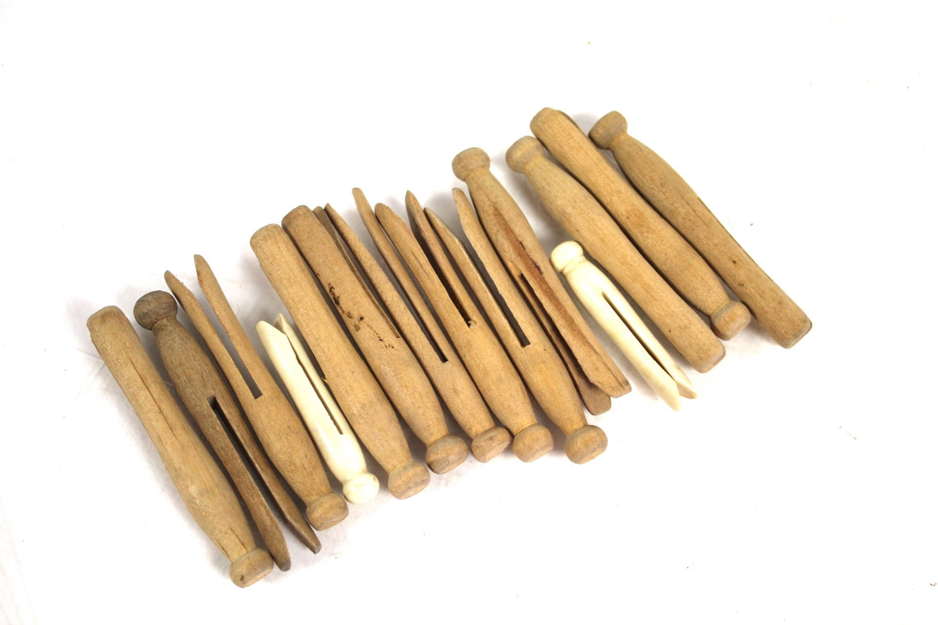 A collection of vintage wood and bone lace pegs