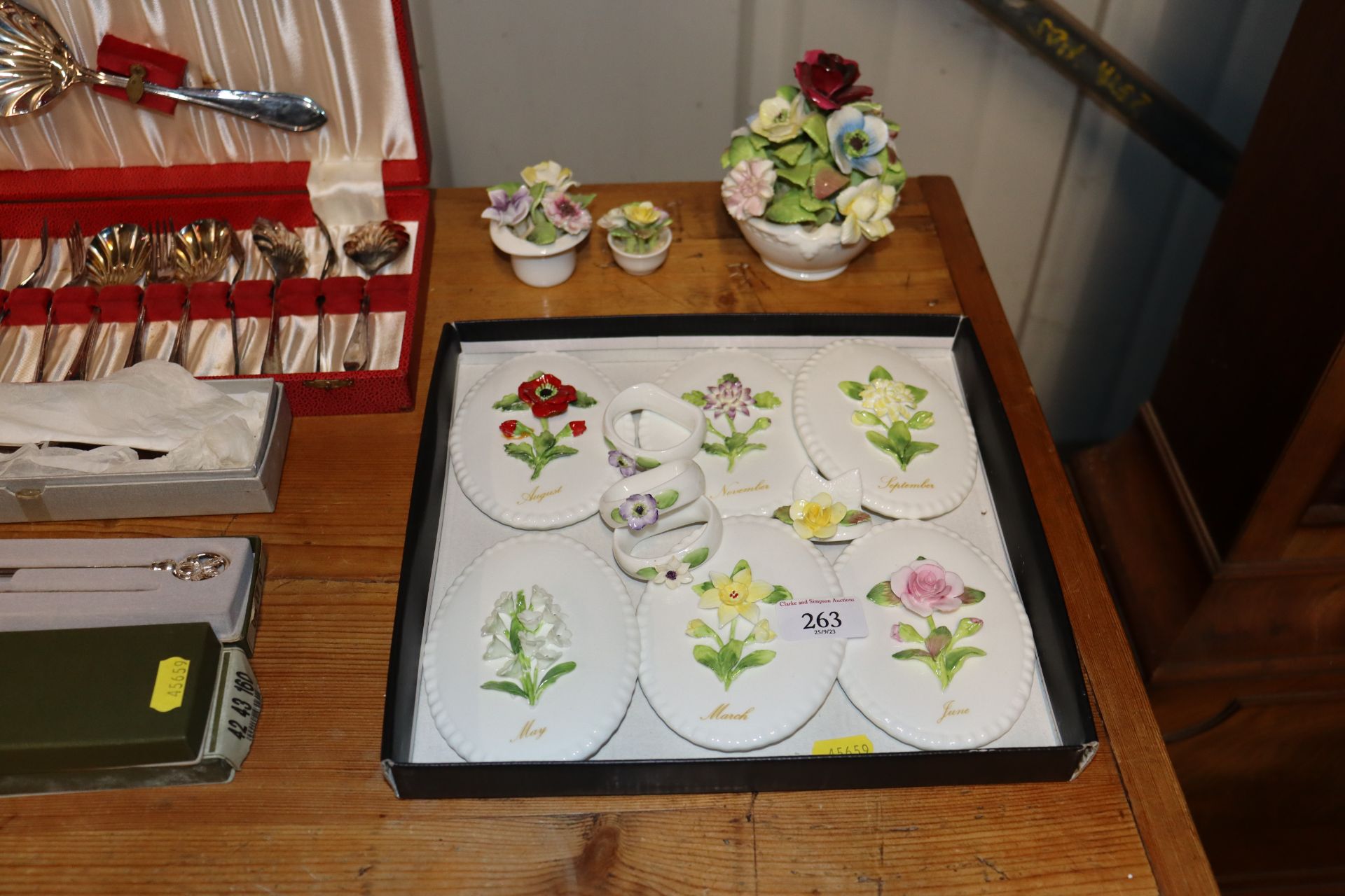 A box containing six Coalport flower month plaques