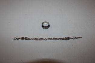 A silver bracelet set with white stones and a dres