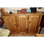 An antique stripped pine kitchen three door cupboa