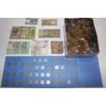 A tin of various coinage and bank notes