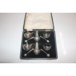 A silver six piece cruet set with four spoons