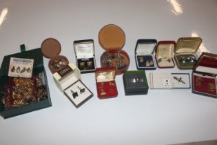 A box containing a large quantity of cuff-links an