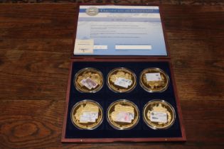 A cased set of six British bank note coins with cer
