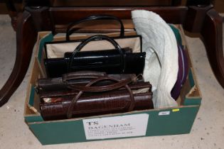 A box containing ladies handbags and hats