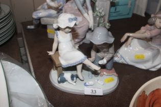 A Lladro figure group depicting young boy and girl