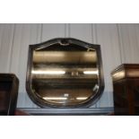 A shaped bevel edged wall mirror