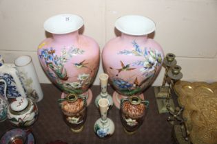 A pair of Victorian opaque glass vases decorated w