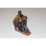 An Art Deco pottery figure in the form of a seated