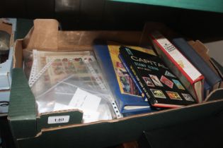 A box containing various stamps, stamp albums and