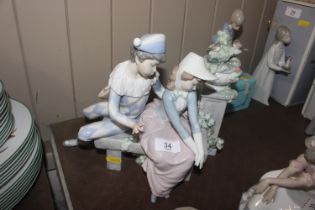 A Nao figure group depicting harlequin and girl on