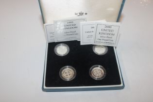 A case of four silver proof £1 coins with certific