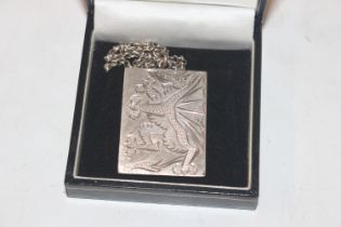 A silver ingot pendant decorated with dragon hung