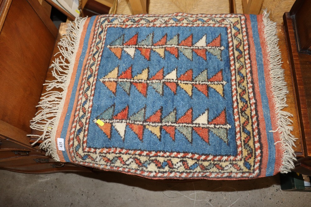A patterned wool rug, approx. 1'10" x 2'