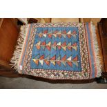 A patterned wool rug, approx. 1'10" x 2'
